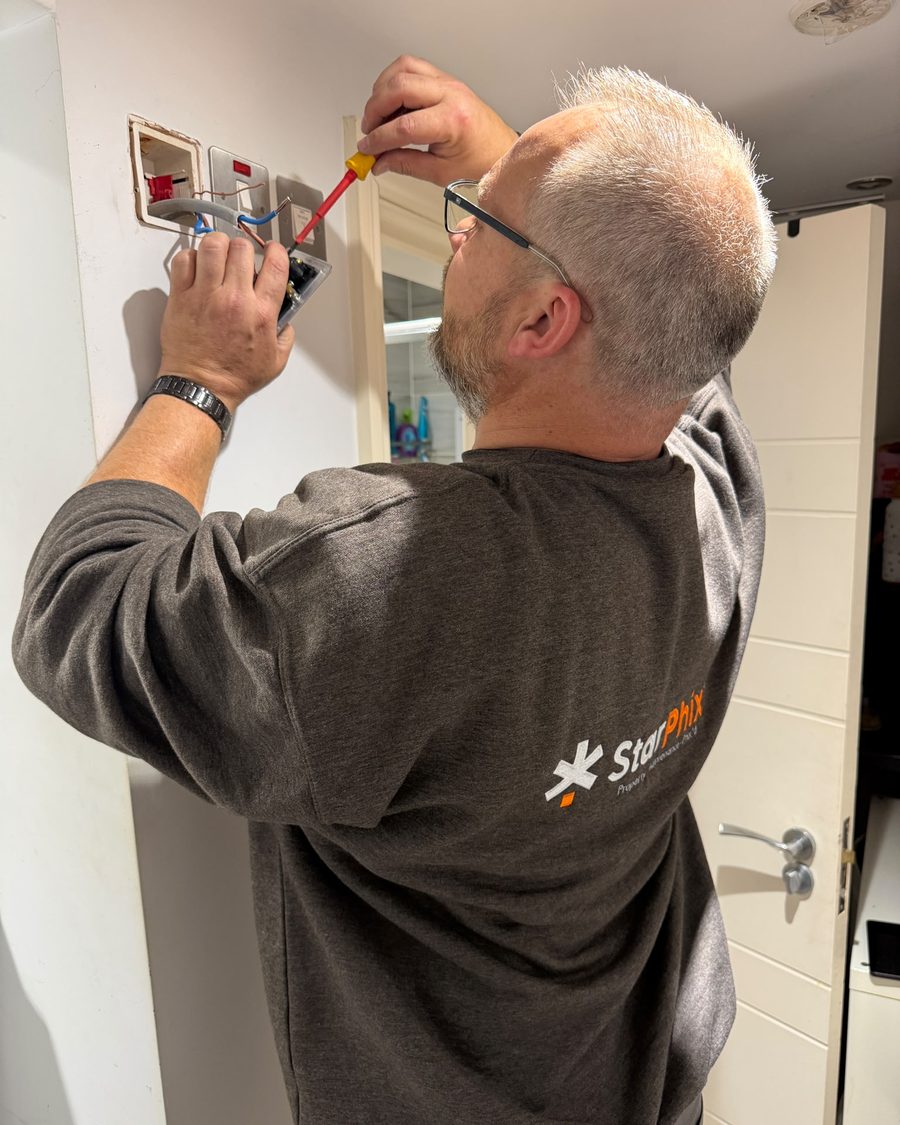 StarPhix electrician fitting a wall switch