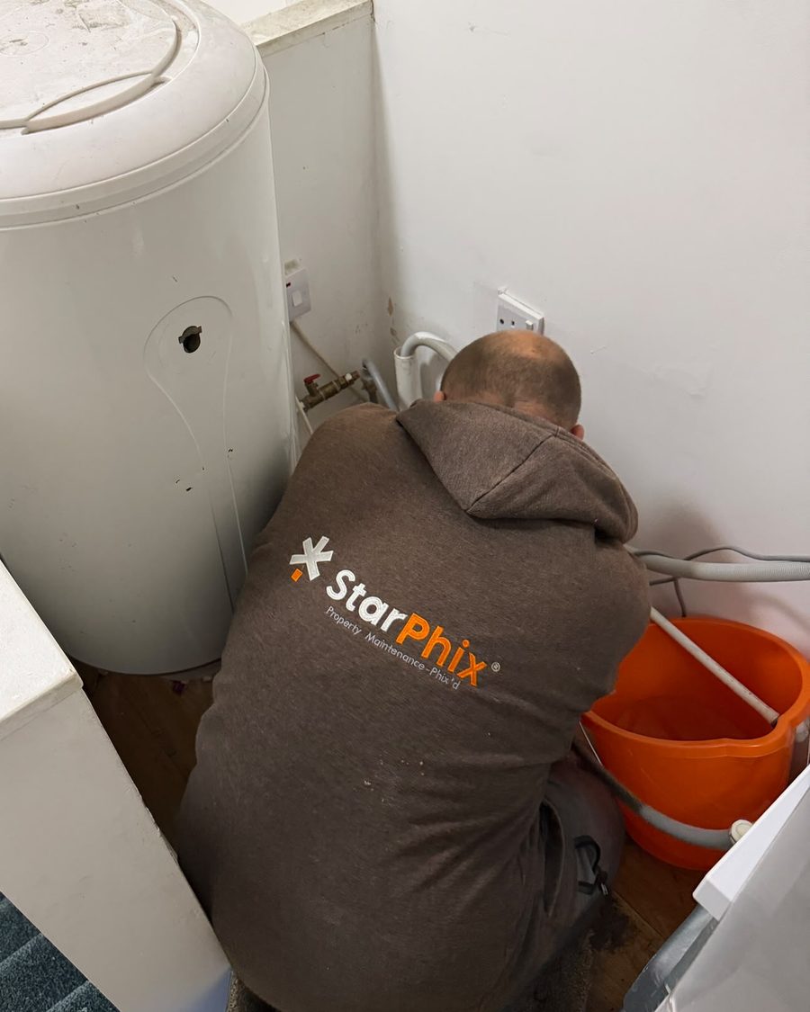 StarPhix team member working on a hot water cylinder